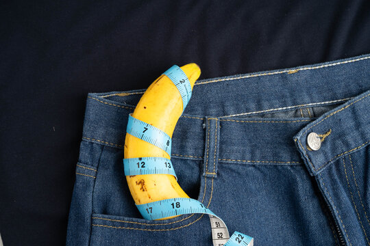 Banana with measuring tape on jean trousers, penis health.
