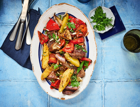 The dish features tender beef chunks mixed with colorful roasted vegetables. Perfect for restaurant menus, food blogs, and social media posts highlighting hearty meals