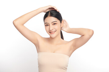 Obraz premium Beautiful Young Asian woman Raises her hands to Showcase clean and hygienic underarms Against a white background, Smooth armpit cleanliness and protection concept