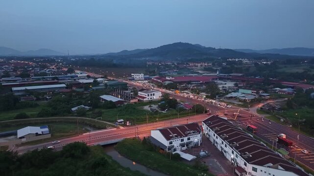 Night aerial footage of vehicular traffic and buildings in Jawi, Penang, Malaysia.