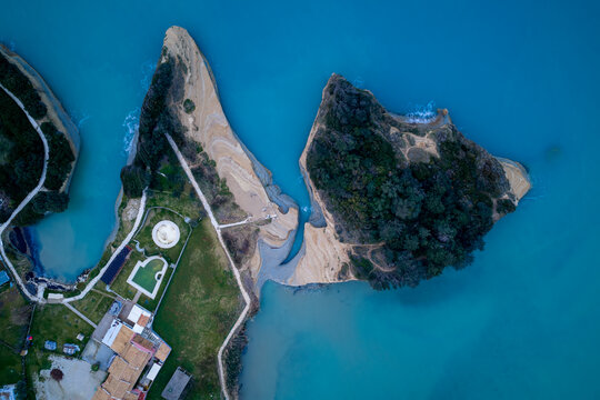 Drone bird's eye view of the famous Canal d'Amour channel of love in Sidari, Corfu island, Greece, showcasing majestic clay cliffs, clear blue water, and picturesque coastal scenery.