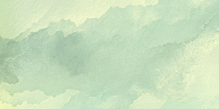 Soft green watercolor texture background with abstract cloudy shapes and subtle gradient effect for design and artistic use