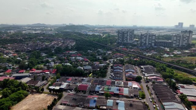 Aerial view shows mixed urban zones. Low-rise homes, factories, and tall buildings coexist at Gelang Patah
