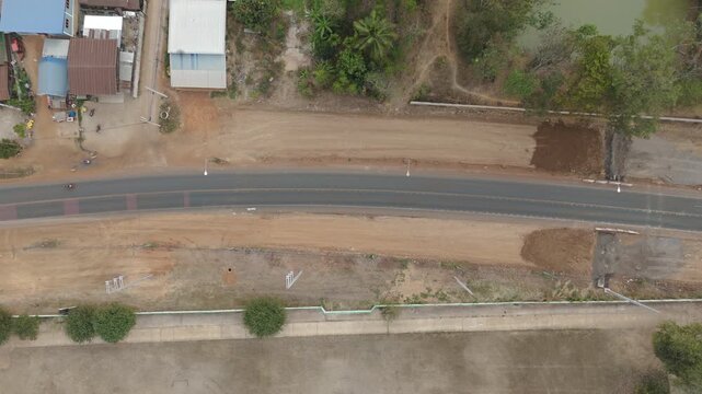 Drone footage a construction working tractor is refining the soil in preparation for laying asphalt The process of making a highway