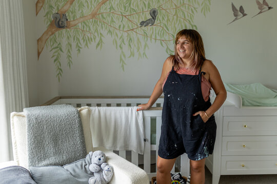 Mural artist in a nursery with whimsical wall art