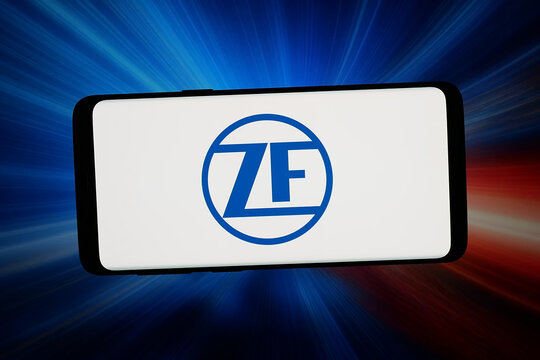 Stuttgart, Germany - 04-08-2026: In this photo illustration, the logo of manufacturing company ZF Friedrichshafen AG is displayed on a smartphone in front of abstract background on computer screen.