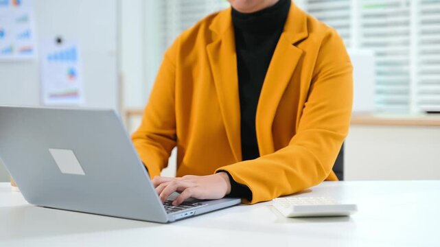Women counting coins on calculator taking from the piggy bank. hand holding pen working on calculator to calculate on desk about cost