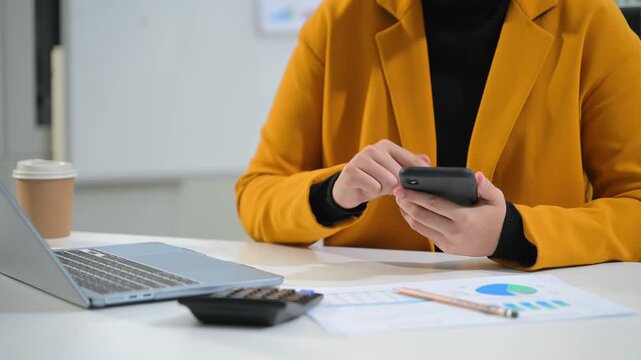Women counting coins on calculator taking from the piggy bank. hand holding pen working on calculator to calculate on desk about cost