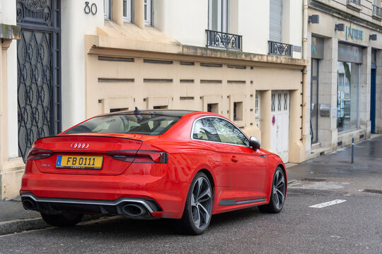 Nancy, France - January 17th 2019 : View on a red Audi RS5 Coup&eacute; finished in Misano Red parked on a street with cars behind and buildings in the background.