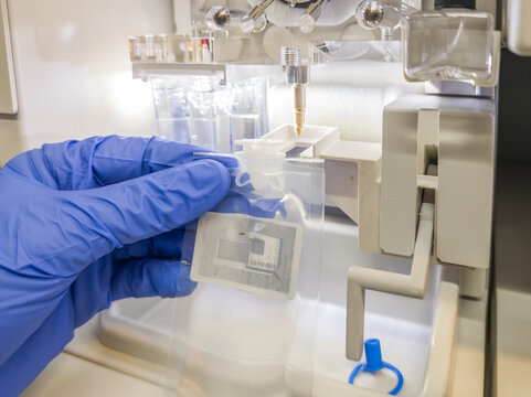Brussels, Belgium. Installing polymer bag in Sanger sequencing instrument