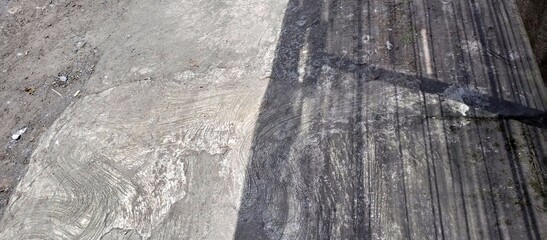 Fototapeta premium Gritty Concrete Road Surface With Sharp Shadow