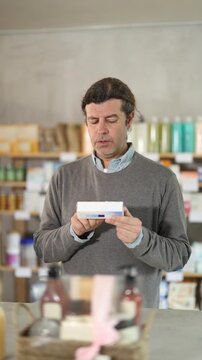 Male buyer buys medicinal ointment at a pharmacy. High quality 4k footage