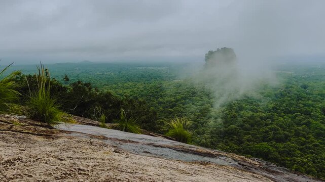 Sigiriya Lion Rock fortress emerging from misty tropical jungle, Pidurangala viewpoint, Sri Lanka