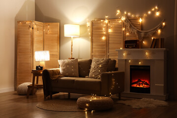Obraz premium Interior of dark living room with sofa, fireplace and glowing lights