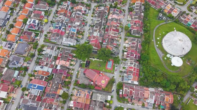Top-down drone shot of SS3 residential neighborhood in Petaling Jaya, Malaysia, showing urban layout, houses, streets, and green park spaces in a modern city environment.