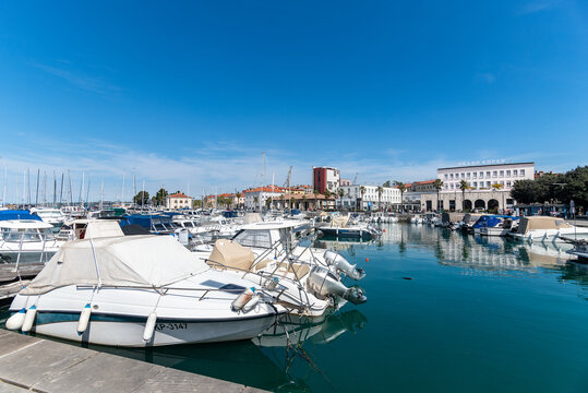 Barche ormeggiate al porto di Capodistria in primavera con cielo blu