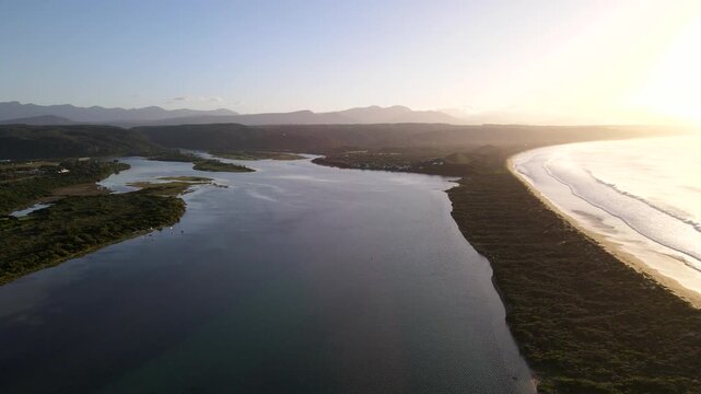 Sunrise aerial view over Keurbooms River Lagoon and long stretch of beach