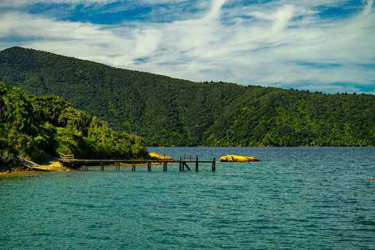 Coastal landscape with jetty and lush green mountains