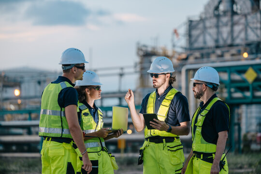 Group of Petroleum Professional Engineer Team Working against Oil Gas Refinery Offshore Survey