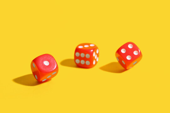 Red game dices on yellow background