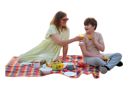 Woman and son having picnic on blanket. Mother and child drinking juice outdoors. Family leisure, summer weekend, healthy food and fruit. Happy lifestyle, outdoor recreation concept.