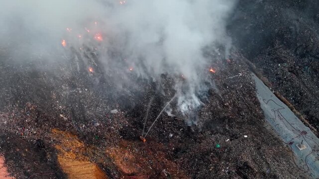 Aerial drone view of fire burning at landfill site