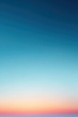 Fototapeta premium The sky displays a smooth gradient from deep blue at the top to soft light at the horizon. This scene captures the beauty of an early morning transition