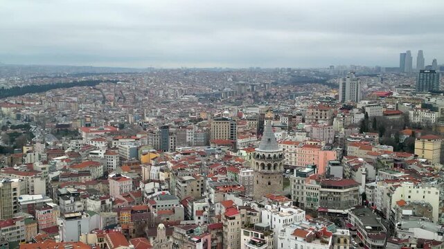 the Galata Tower, business part of the city in the background fly away shot