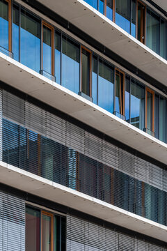 Urban exterior architecture features colorful modern apartment building facade where pattern and windows create a vibrant residential texture
