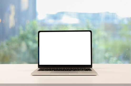 close up isolated on blank white screen display of laptop computer on table inside office room for add content of design banner , website or template or online shopping e-commerce concept