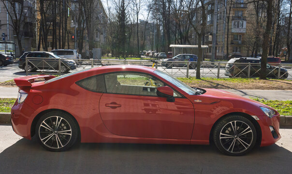 Red Japanese sport car Toyota GT86 GR Sport at the city street. Exterior of a fast Japanese two-door coupe Toyota GT 86 2.0 GR Sport  on parking lot. JDM cars. Japanese sport coupe in parking lot. 