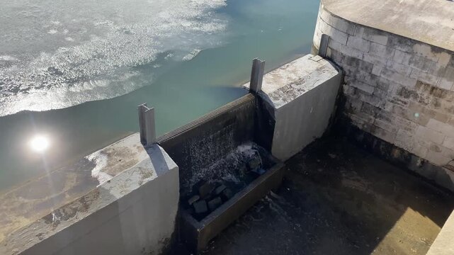 Water overflowing the weir. Active melting of ice, spring flood. Stop Log Weir or Flashboard Dam. Water level control structure.