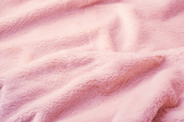 Detailed close up abstract of soft pink fluffy fabric with wavy comfortable textile texture background material © reddish