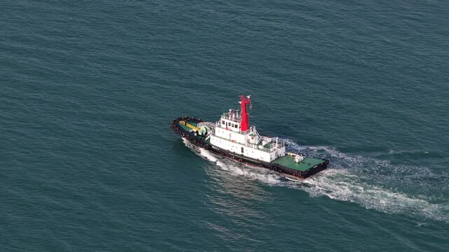 Aerial view of a tugboat navigating the open sea