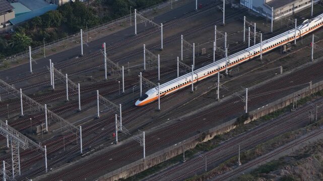 Aerial view of high speed train departing from railway depot