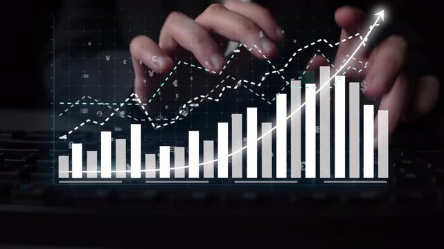 A close-up view of hands typing on a keyboard, alongside a modern digital graph showcasing data trends and analytics in a contemporary workspace setting. Copula
