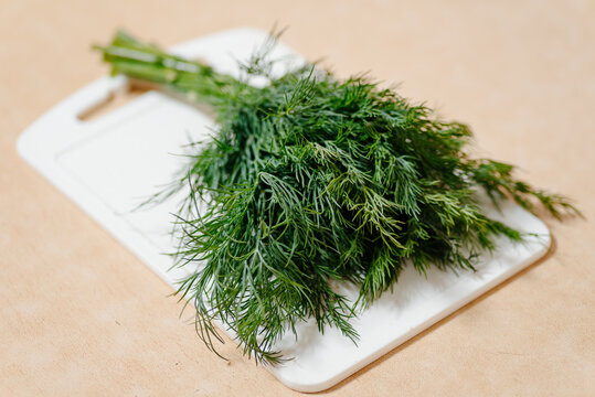bunch of green dill on white board, healthy food, greenery