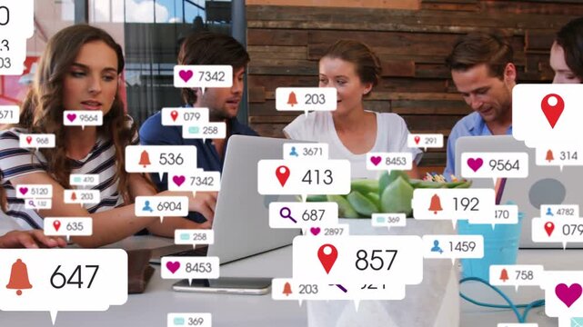 Marketing team tapping laptops and talking while social alerts growing, layering over team for ads