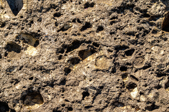 Porous volcanic tuff rock texture vesicles cavities pyroclastic structure geological petrographic analysis natural stone surface