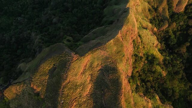 Mt Masapinit Toong Tuy Batangas Philippines elevated perspective capturing mountain contours glowing under warm sunset light.
