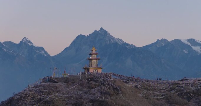 Aerial drone shot capturing the Buddhist monument and colorful prayer flags at the Ama Yangri viewpoint in Helambu Nepal overlooking the majestic Gauri Shankar Himalayan range.