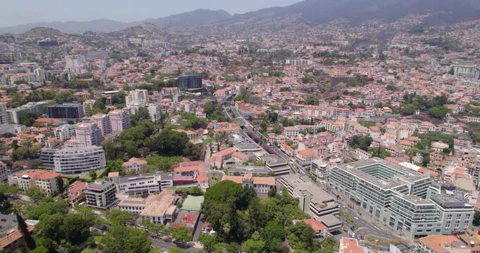 Panoramic drone sweep over the dense hills and residential houses of Funchal.