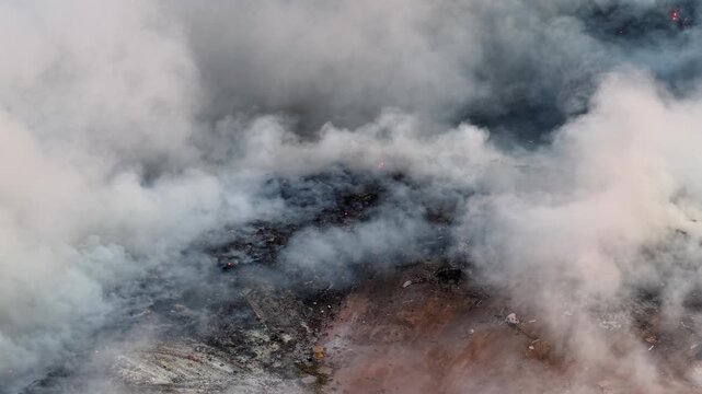 Aerial drone view of fire burning at landfill site