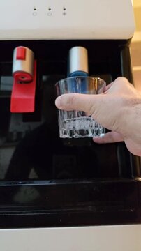 Drinking hygienic clean water from the dispenser. Mineral water