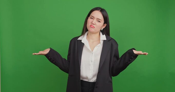 Confused businesswoman shrugging her shoulders on a green screen.