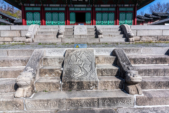 Ornate Stone Carvings and Guardian Statue on the Palace Stairs,