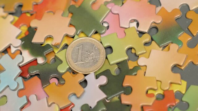 One Euro Coin on Colorful Jigsaw Puzzle Pieces - Business Solution and Financial Success Concept 4K