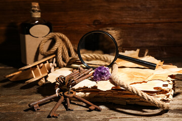 Travel equipment with old manuscripts and mineral stone on brown wooden background © Pixel-Shot