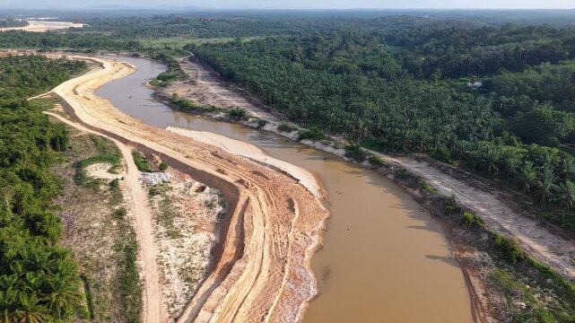 Bare earth splits the river's brown waters