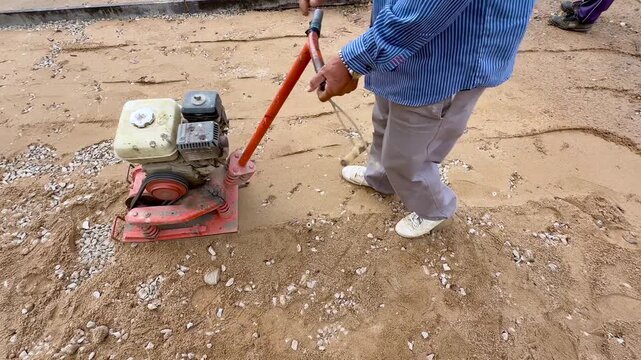 Top Down View of Plate Compactor Machine Leveling Ground Surface for Construction Base